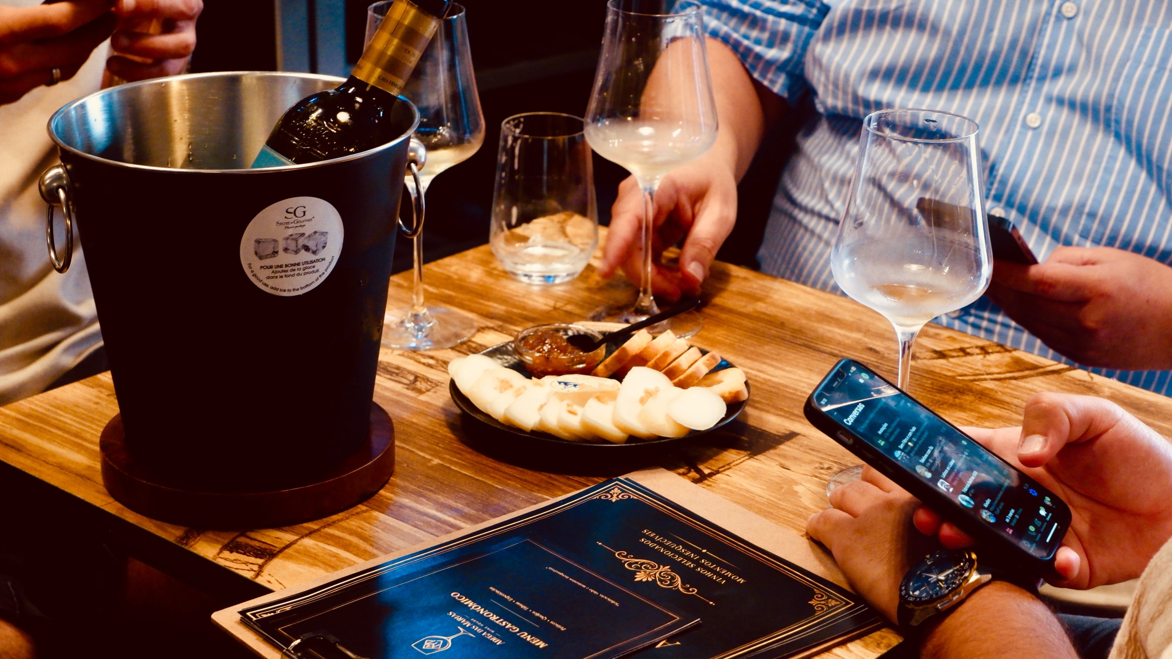 Mesa com vinhos e tábua de queijos na Adega das Marias